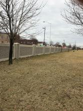 Two-color concrete stain system on exterior precast stone wall