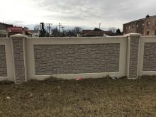 Two-color concrete stain system on exterior precast stone wall
